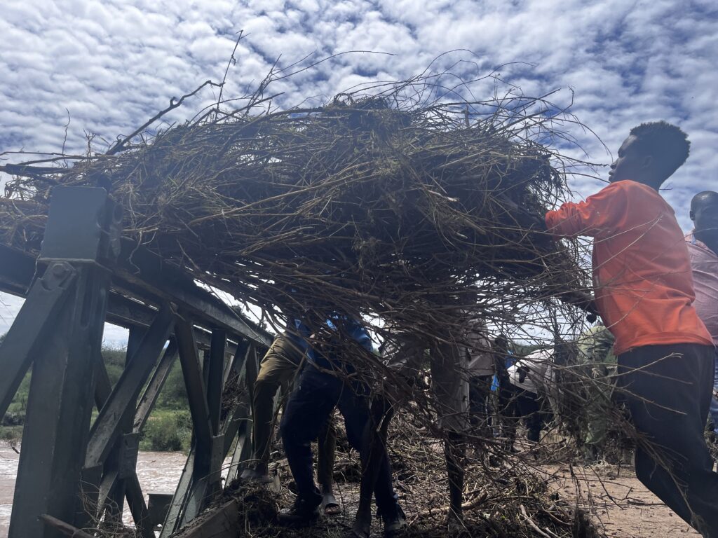 Mpala staff clearing debris from the bridge.