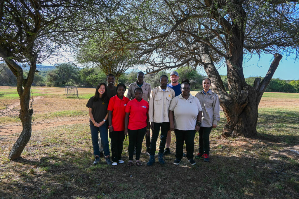 Godfrey Gitimu with the IPIL team and Daraja Academy students